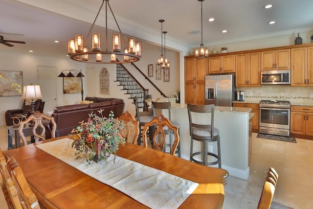 3222 W Empedrado St, Tampa, FL 33629 - dining space featuring visible vents, crown molding, stairs, recessed lighting, and ceiling fan with notable chandelier