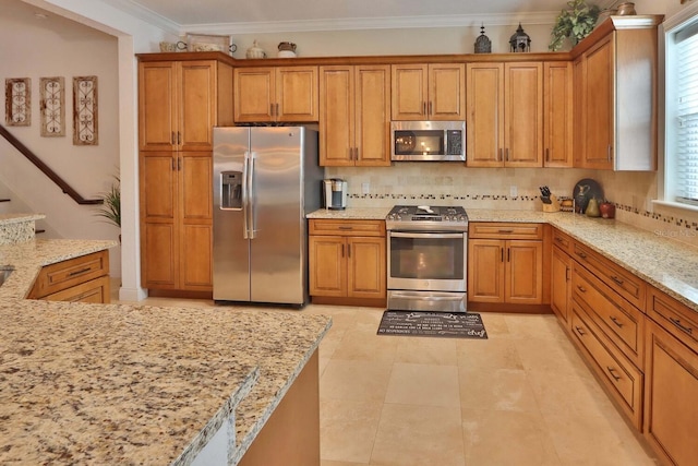 3222 W Empedrado St, Tampa, FL 33629 - kitchen with stainless steel appliances, crown molding, and brown cabinetry