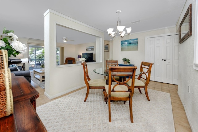 dining space with ceiling fan with notable chandelier, ornamental molding, and light tile patterned flooring