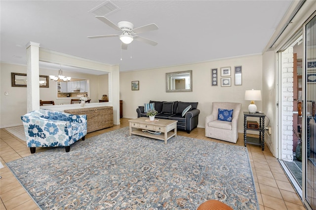 tiled living room featuring ceiling fan with notable chandelier and ornamental molding