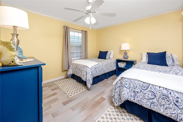 bedroom with ceiling fan and crown molding