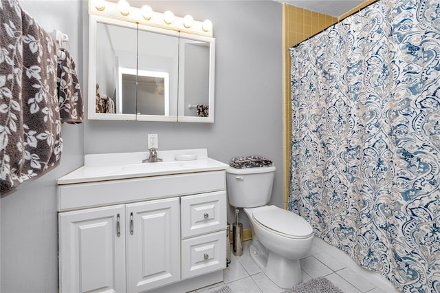 bathroom featuring toilet, tile patterned floors, and vanity