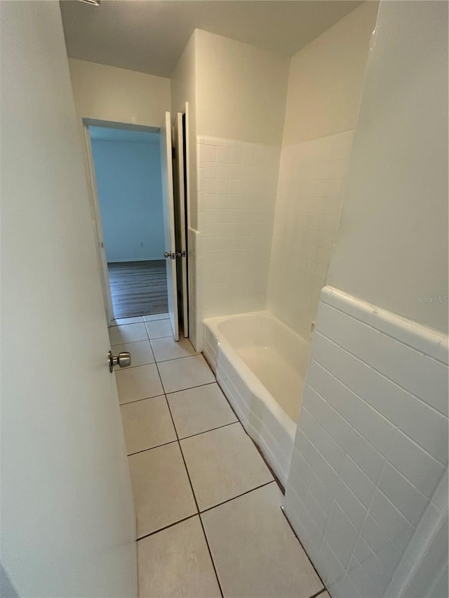 bathroom featuring a bath and tile patterned floors