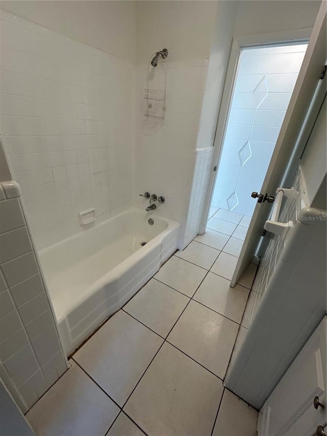 bathroom with tile patterned floors and tiled shower / bath combo