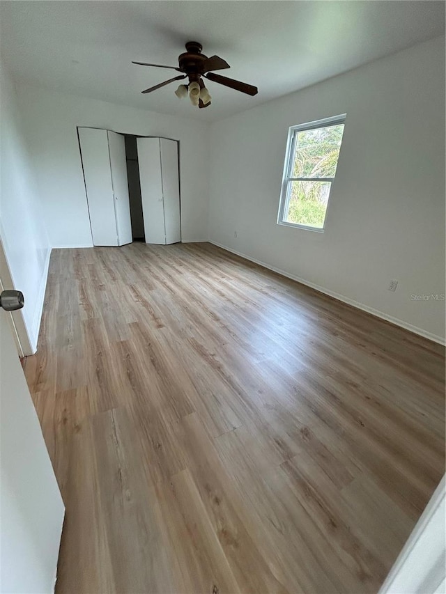 unfurnished bedroom featuring ceiling fan and light hardwood / wood-style flooring