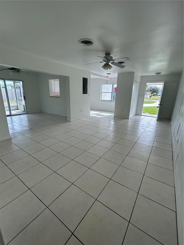 tiled empty room with ceiling fan