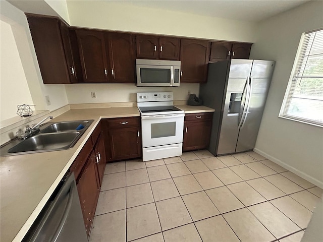 183 Bamboo Dr Unit B, Port Charlotte, FL 33954 - kitchen with appliances with stainless steel finishes, dark brown cabinets, and light tile patterned flooring