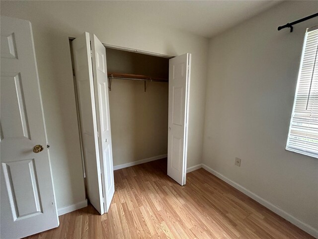 183 Bamboo Dr Unit B, Port Charlotte, FL 33954 - unfurnished bedroom with light wood-style floors and a closet