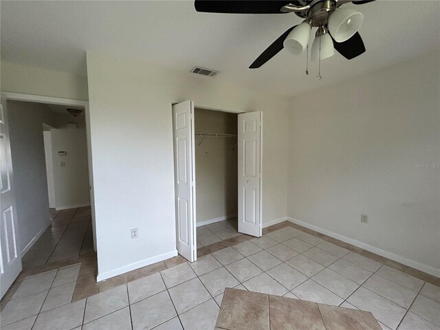 183 Bamboo Dr Unit B, Port Charlotte, FL 33954 - unfurnished bedroom featuring light tile patterned floors, a closet, and a ceiling fan