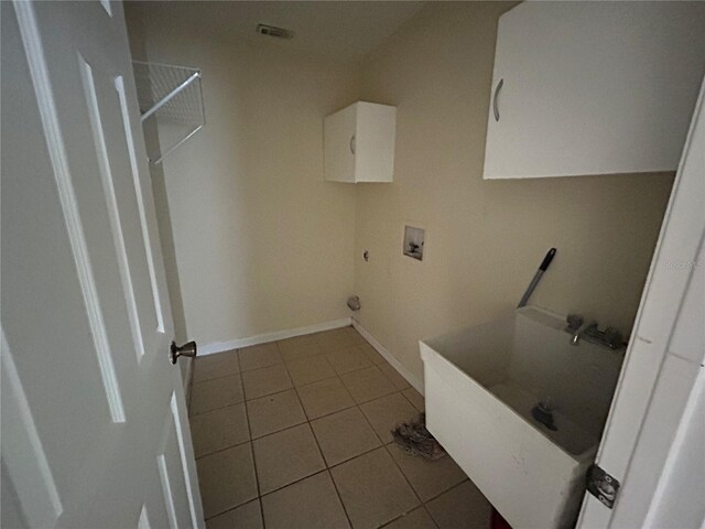 183 Bamboo Dr Unit B, Port Charlotte, FL 33954 - washroom with washer hookup, cabinet space, and tile patterned flooring