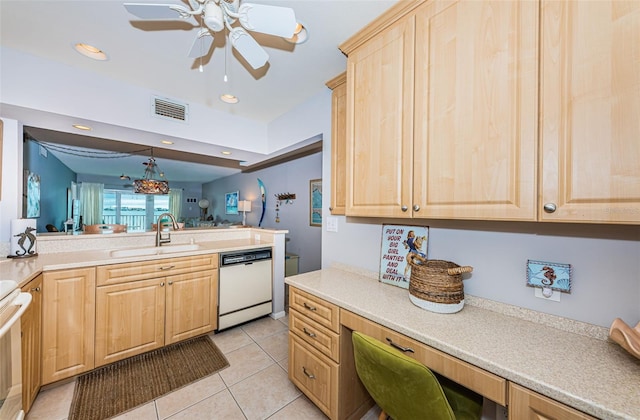 kitchen with sink, light tile patterned floors, hanging light fixtures, white dishwasher, and light brown cabinetry