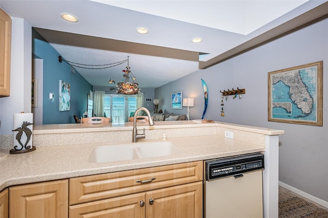 kitchen featuring decorative light fixtures, dishwasher, sink, and light brown cabinets