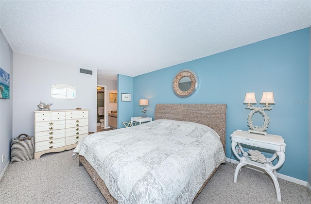 bedroom featuring carpet and a textured ceiling