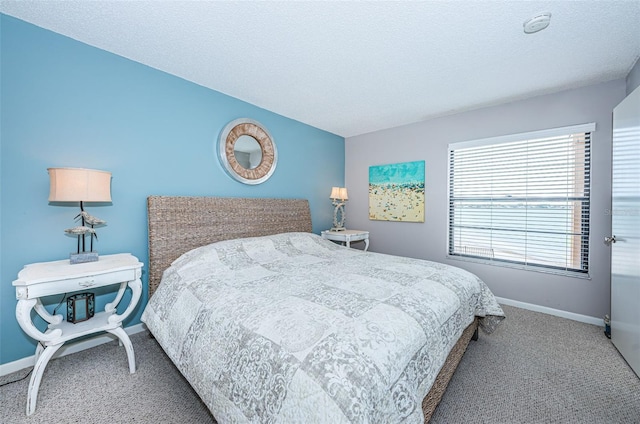 bedroom with carpet floors and a textured ceiling