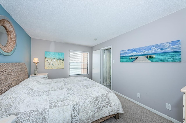 carpeted bedroom with a textured ceiling