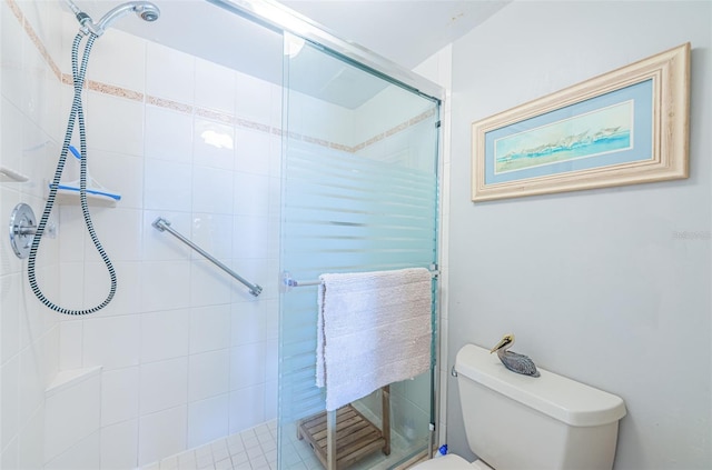 bathroom with an enclosed shower and toilet