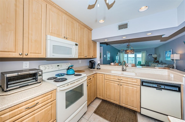 kitchen featuring light brown cabinetry, sink, light tile patterned floors, kitchen peninsula, and white appliances