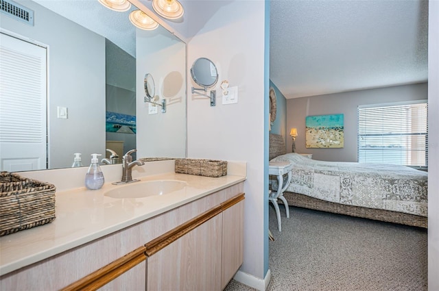 bathroom featuring vanity and a textured ceiling