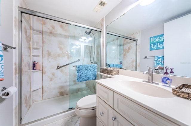 bathroom with vanity, toilet, an enclosed shower, and tile patterned flooring