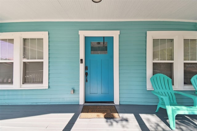 view of exterior entry with a porch