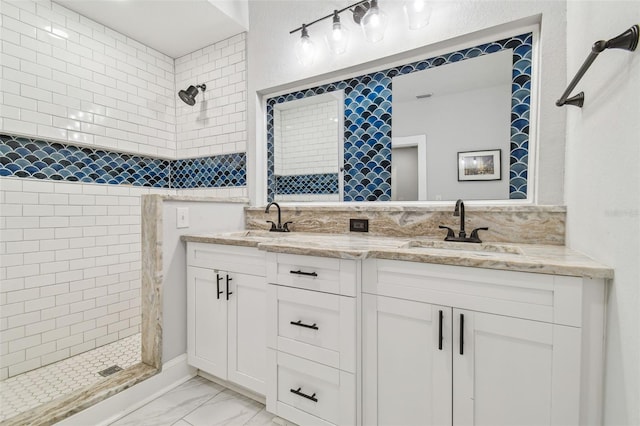 bathroom featuring vanity and tiled shower