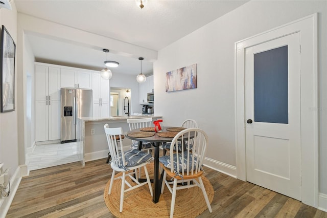 dining room with sink and hardwood / wood-style floors