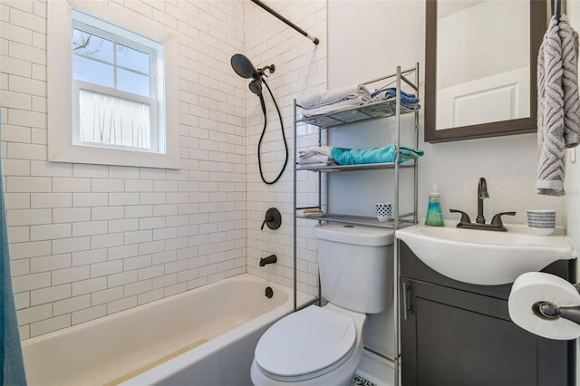 full bathroom with vanity, toilet, and tiled shower / bath