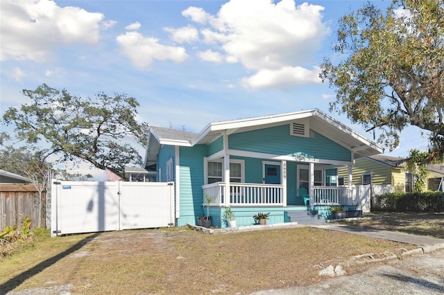 bungalow with a porch and a front yard