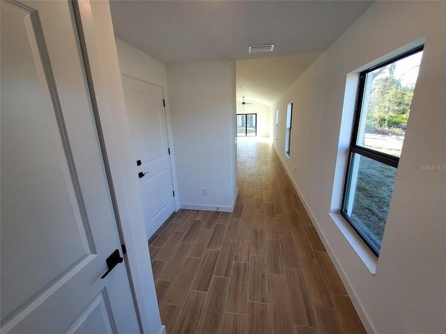 corridor featuring wood-type flooring