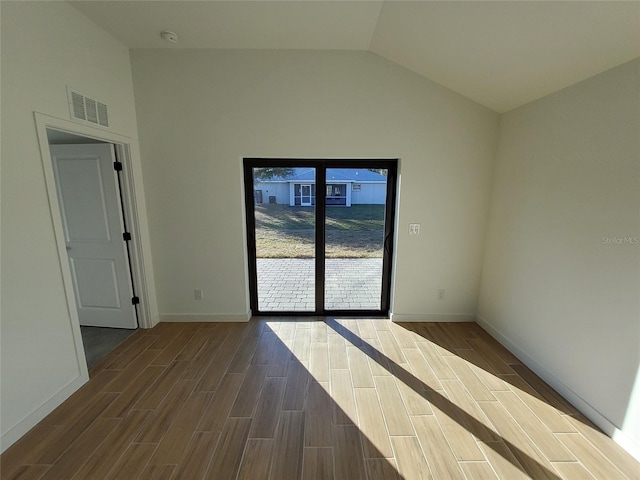 empty room featuring vaulted ceiling