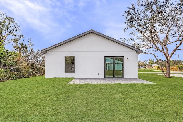 3418 Eagle Pass St, North Port, FL 34286 - back of property featuring stucco siding, a yard, and a patio
