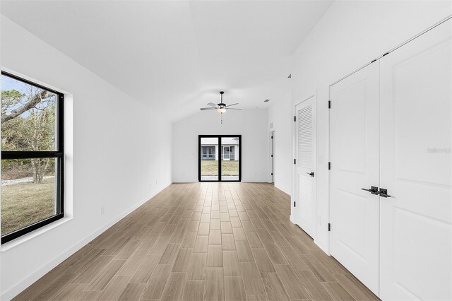 3418 Eagle Pass St, North Port, FL 34286 - empty room featuring baseboards, lofted ceiling, light wood-style flooring, and ceiling fan