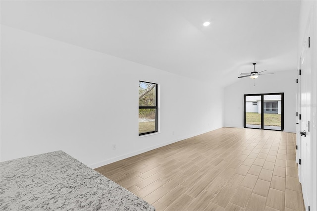 3418 Eagle Pass St, North Port, FL 34286 - empty room with light wood-style flooring, a ceiling fan, vaulted ceiling, and a wealth of natural light