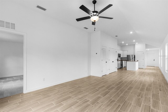 3418 Eagle Pass St, North Port, FL 34286 - unfurnished living room featuring light wood-type flooring, baseboards, ceiling fan, and visible vents