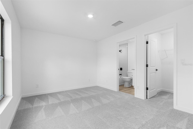 3418 Eagle Pass St, North Port, FL 34286 - unfurnished bedroom featuring carpet floors, a walk in closet, baseboards, and visible vents
