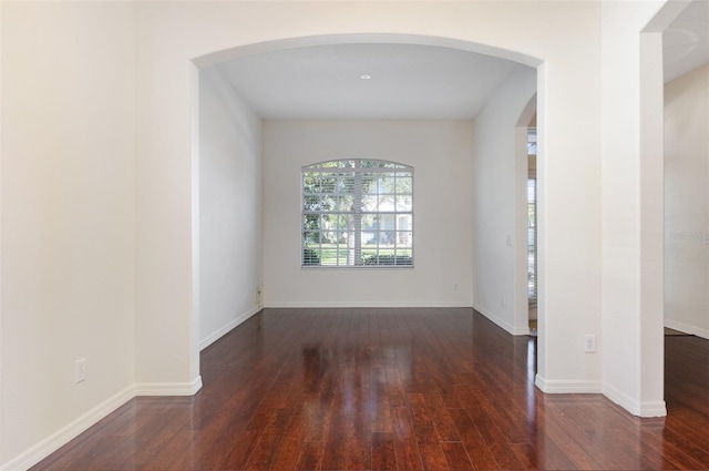 spare room with dark hardwood / wood-style flooring