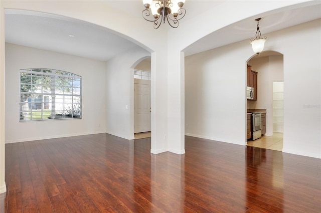 unfurnished room with light hardwood / wood-style floors and a notable chandelier