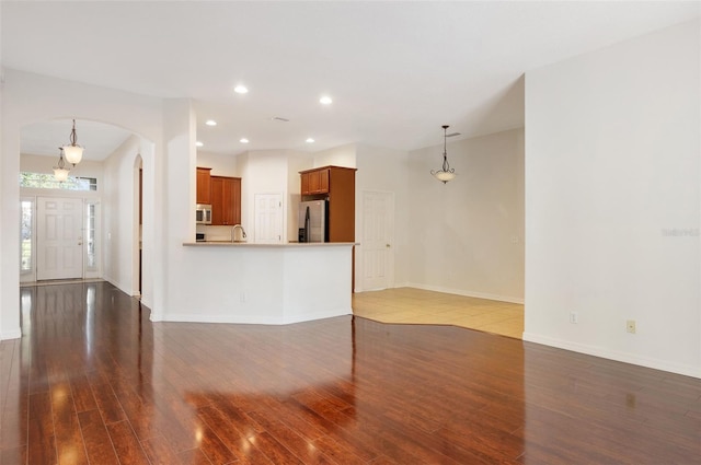 unfurnished living room featuring dark hardwood / wood-style flooring