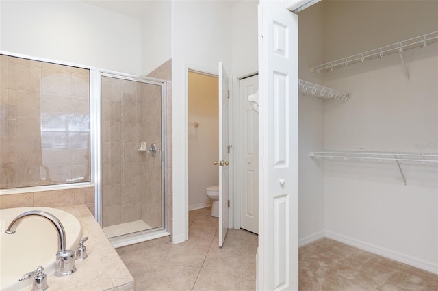 bathroom featuring toilet, an enclosed shower, and tile patterned flooring