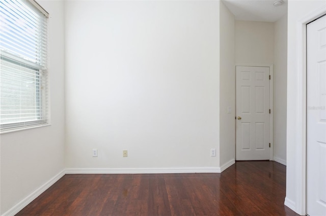 empty room with dark hardwood / wood-style floors