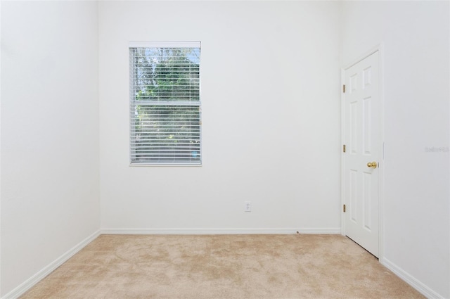 spare room featuring light colored carpet