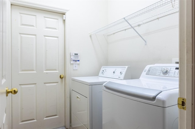 washroom with independent washer and dryer