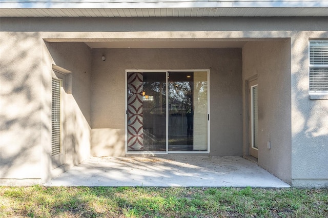 property entrance featuring a patio