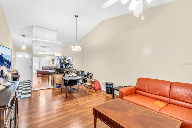 living room featuring ceiling fan, hardwood / wood-style floors, and lofted ceiling