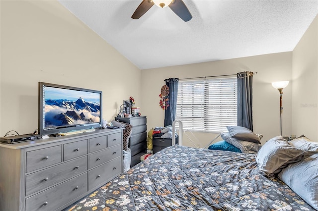 bedroom featuring ceiling fan, a textured ceiling, and vaulted ceiling