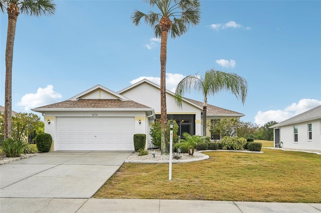 view of front of house featuring a garage and a front lawn