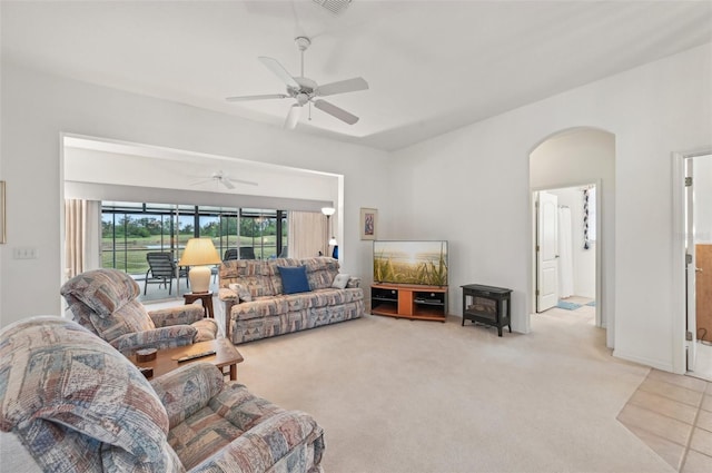 carpeted living room with ceiling fan