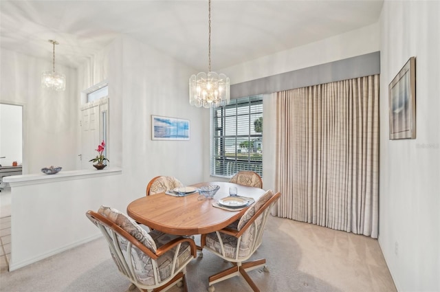 dining room featuring light carpet and a notable chandelier