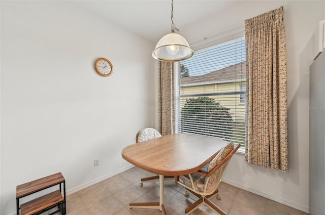 dining area with a wealth of natural light and light tile patterned flooring