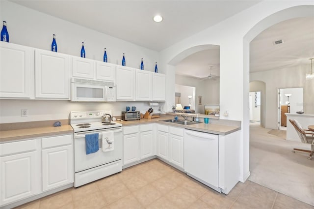 kitchen featuring ceiling fan, sink, light colored carpet, white cabinetry, and white appliances